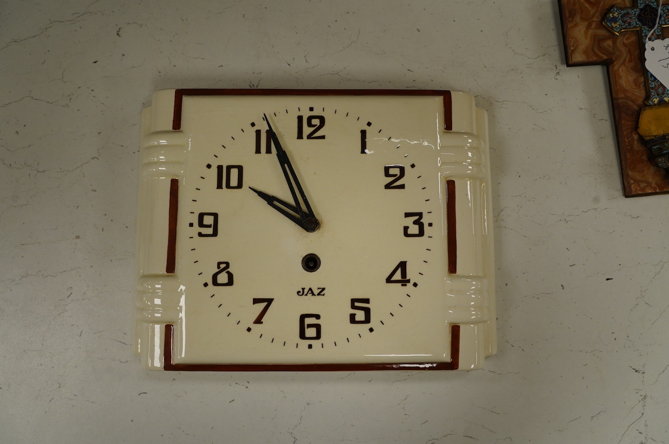 An Art Deco Jaz porcelain wall clock, 23cm high. Condition - fair, surface rust to the case of the movement, etc.